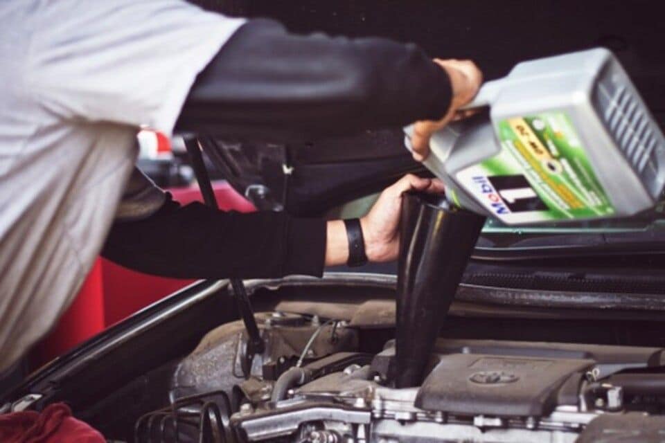 Engine oil being topped up in a car
