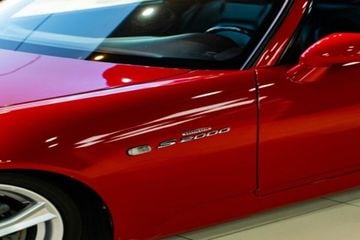 Side profile of a Red Honda S2000 sports Car.