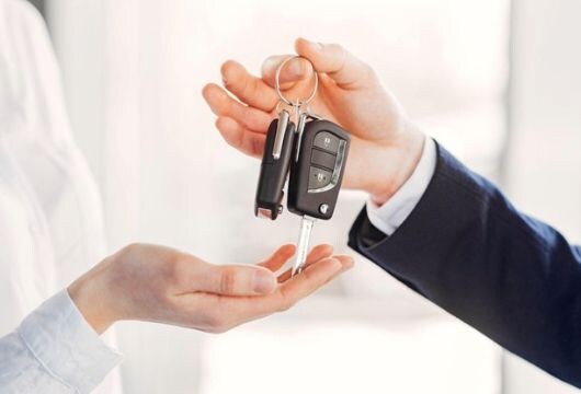 A man handing over car keys