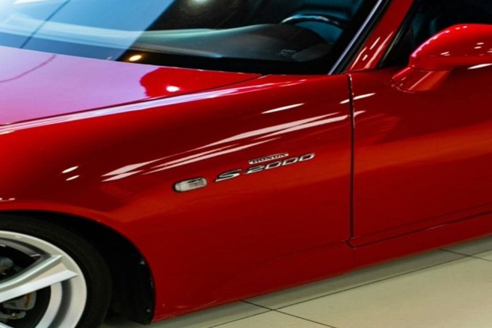 Side profile of a Red Honda S2000 sports Car.