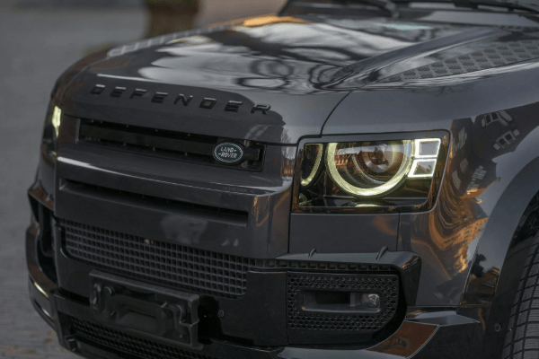 A grey land rover defender's front end