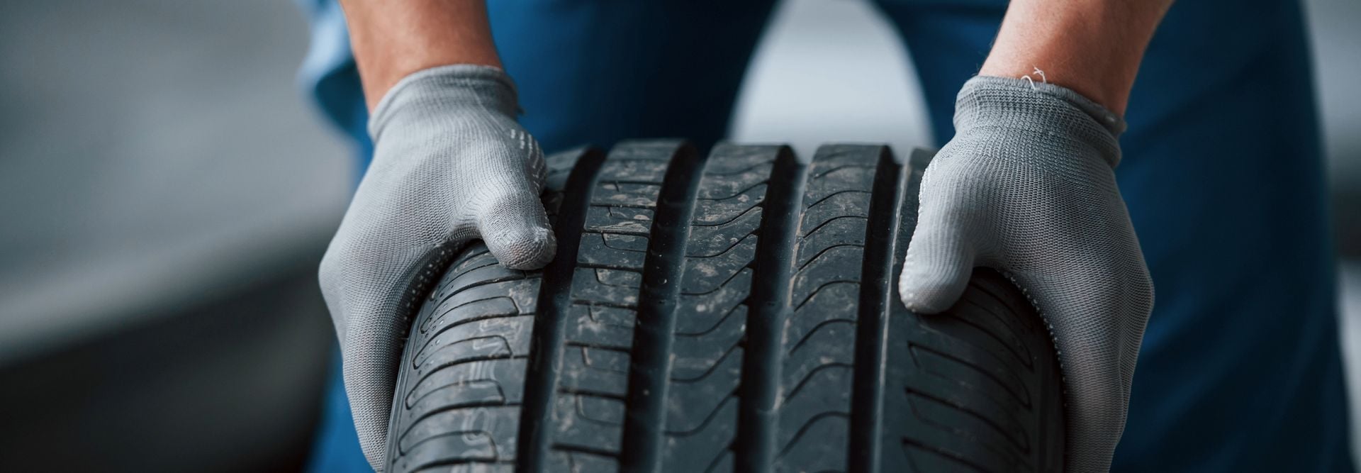 Man in a blue uniform checks the car