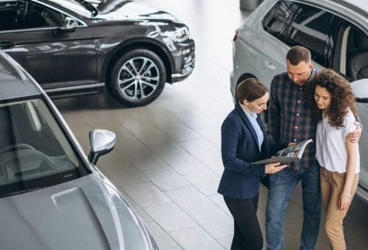 A Sales person in a showroom serving customers