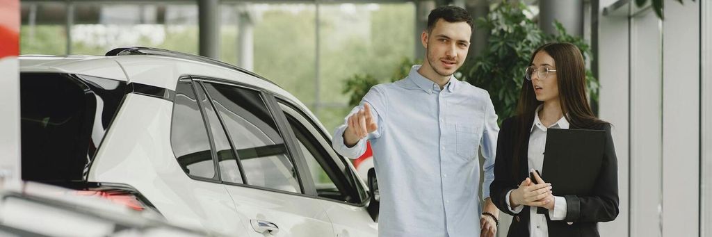 Stylish and elegant people in a car salon. Source: https://www.freepik.com/