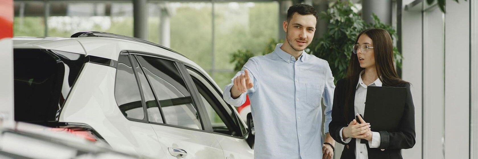 Stylish and elegant people in a car salon. Source: https://www.freepik.com/