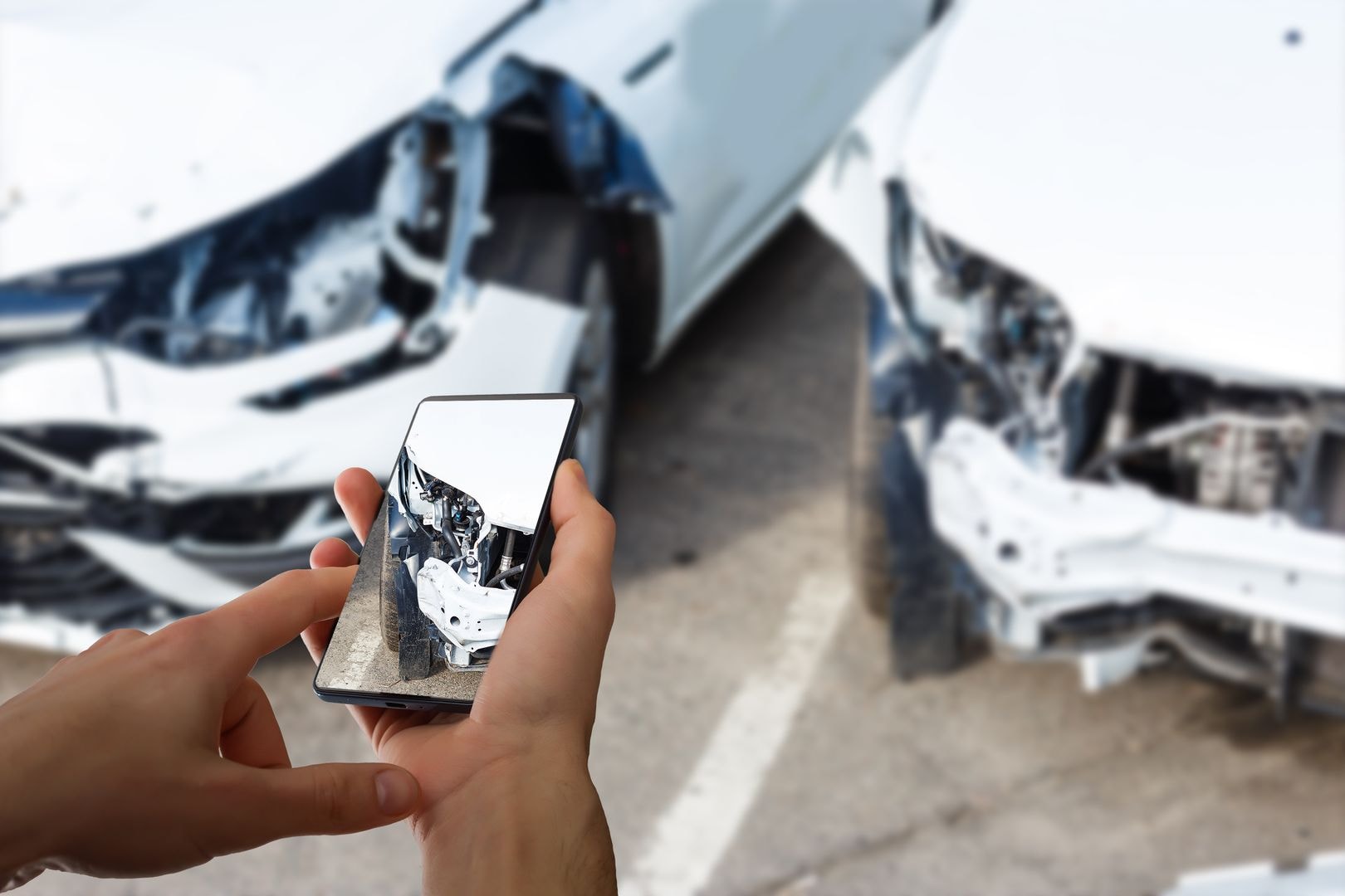 Person reporting traffic accident with pictures on mobile phone