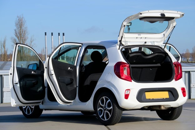 A white hatchback with its doors open