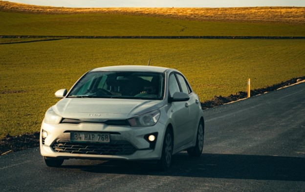 A White Kia Rio on Road