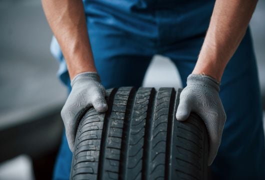 Man in a blue uniform checks the car