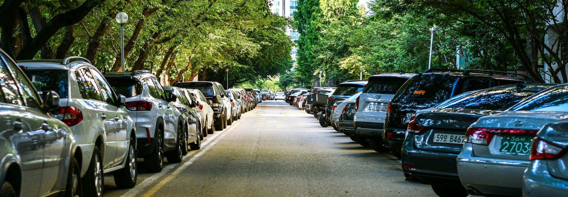 Cars parked on either side of a street