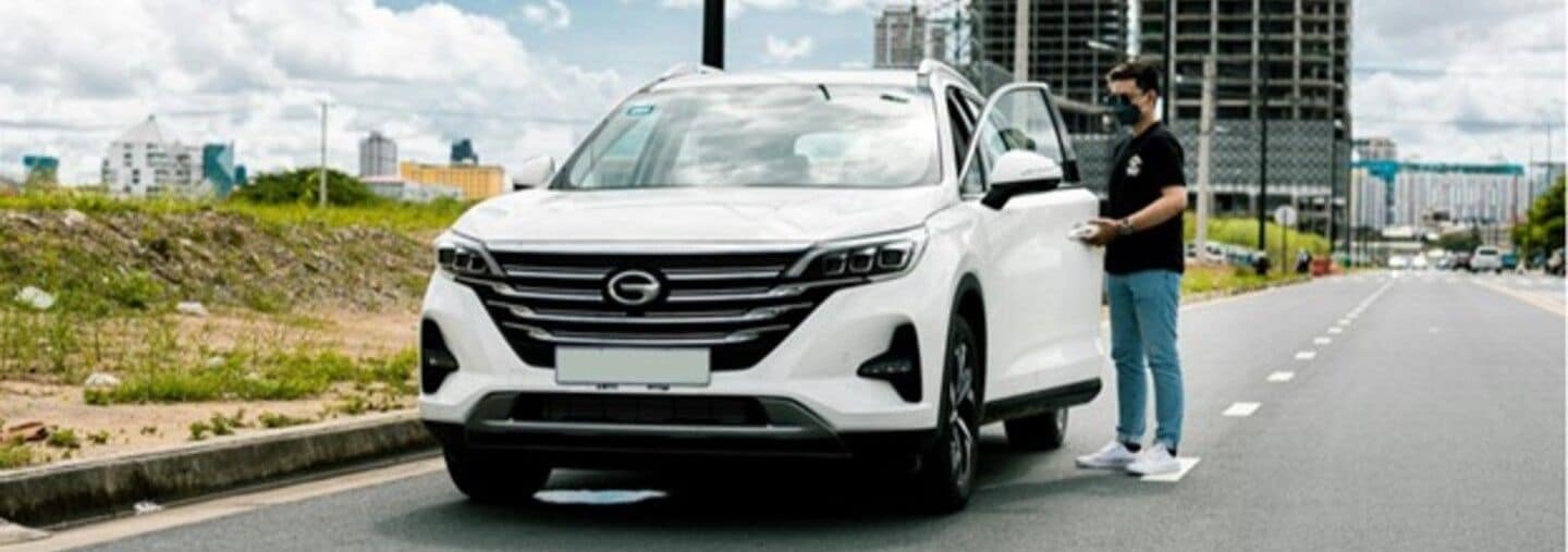 GAC SUV parked on a city street with a person standing nearby