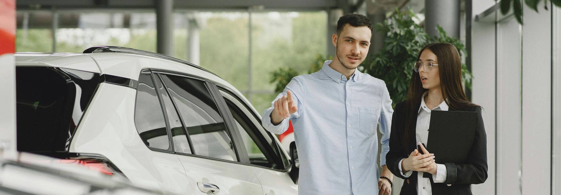 Stylish and elegant people in a car salon. Source: https://www.freepik.com/