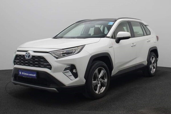 Side view of a white Toyota RAV 4 Hybrid car
