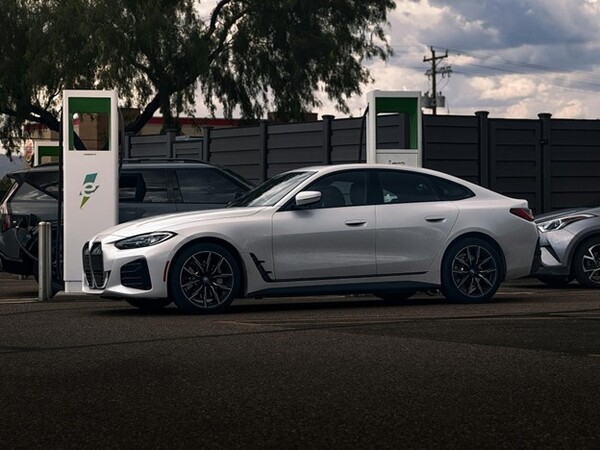 A White BMW i4 Parked by the Chargers
